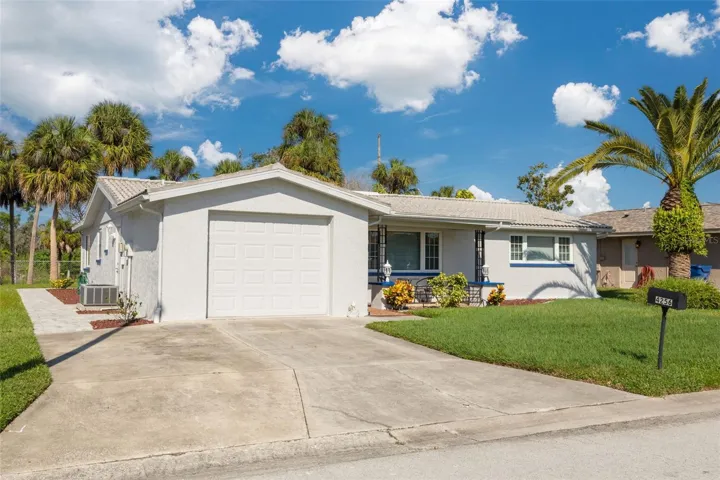 Large driveway, paved sidewalk to the back of property