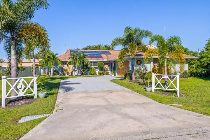 FRONT VIEW WITH LUSH LANDSCAPING AND MATICULOUS LAWN