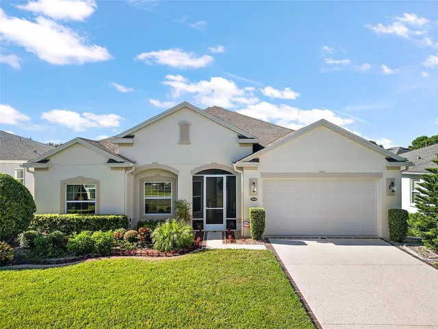 Picture Perfect, Beautiful Landscaped Flower Beds and Manicured Lawn with concrete curbing around the whole house with River Rock .