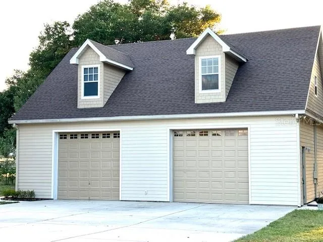 Concrete driveway for parking. Entry door on right side of building.