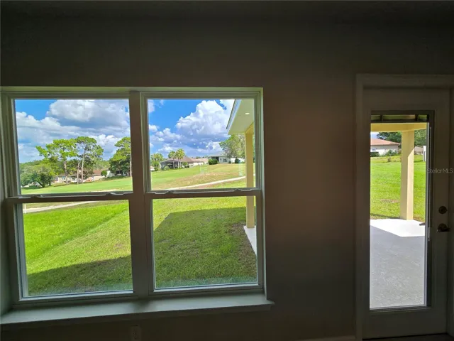 living room back window and door to covered lanai