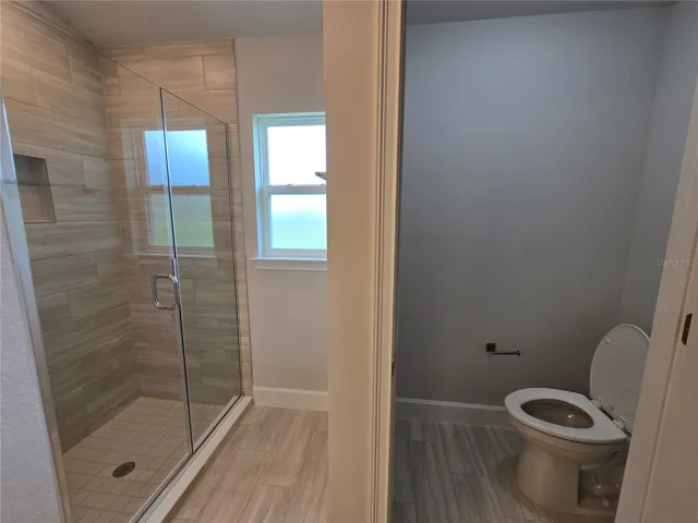 main bath tiled shower and water closet