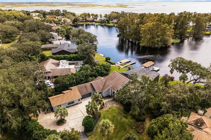 Aerial view of the property showing the lake and circular driveway.