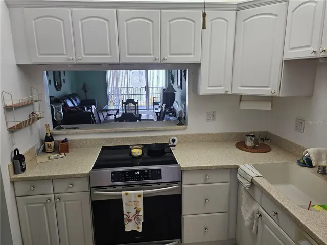 From Kitchen viewing into living area, Sliding door and balcony.