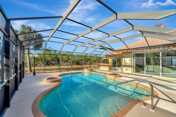 Look at this pool area and outdoor kitchen with Lake views