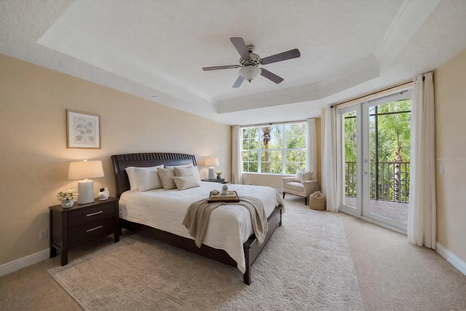 Virtually staged primary bedroom with private access to Lanai and 2 walk-in closets