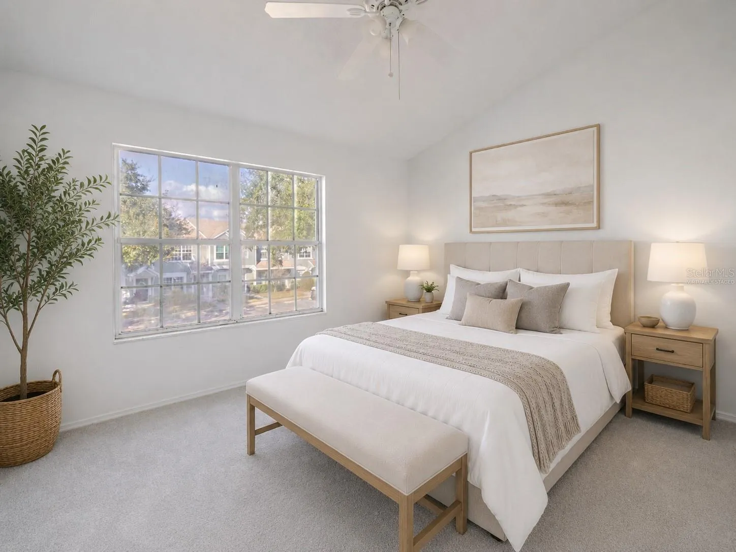 The 2nd bedroom features carpet, a ceiling fan with light kit and vaulted ceiling. (Photo has been virtually staged.)