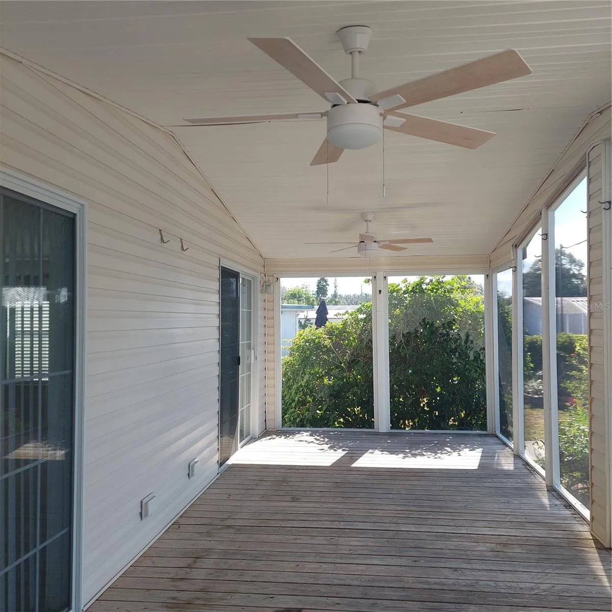 gorgeous screened front porch high ceiling, 2 new ceiling fans, exterior door and 2 sets of sliding glass doors to house