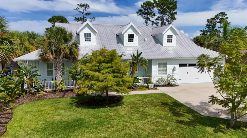 front view with mature palms and ornamentals