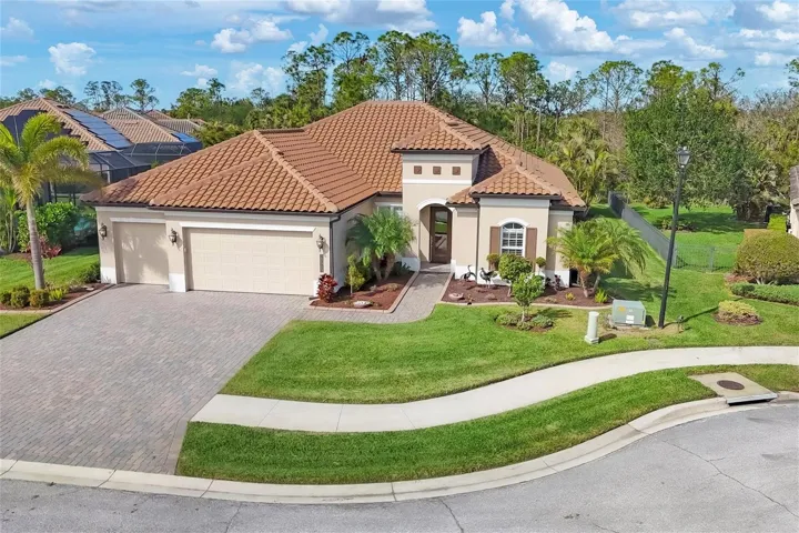 This is a stunning home with a paved driveway and beautiful landscaping.