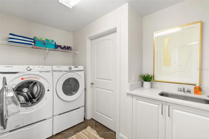 Laundry room with sink and extra cabinetry