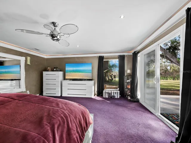 Primary bedroom with sliders to deck and pond/garden views