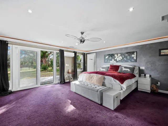 Primary bedroom with sliders to deck and pond/garden views