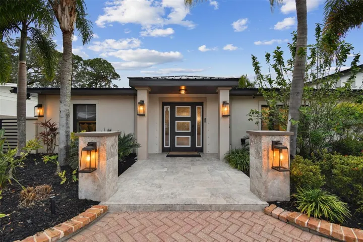 Inviting landscaping and lighting features offer a beautiful entrance!
