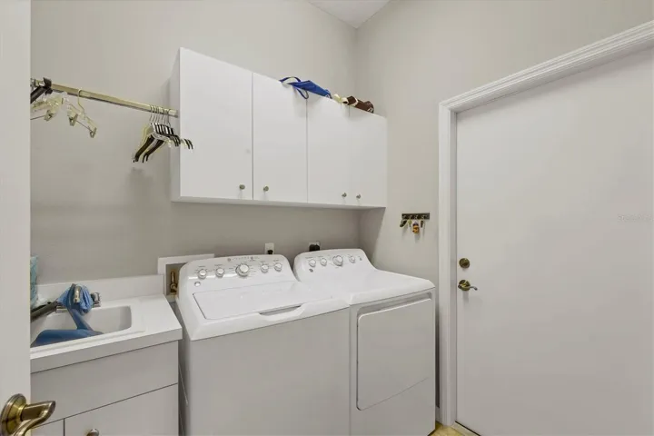 Laundry room includes a utility sink.  It's located between the kitchen & the garage