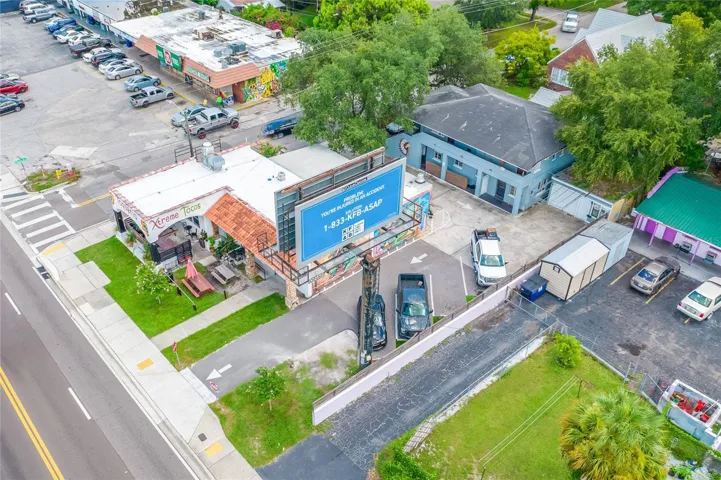 Xtreme Tacos Building, Quad-plex to the rear, Storage garage to the right of apartments, Billboard on land lease