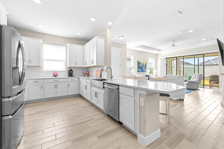 Huge Kitchen with Gas Stove, Quartz Countertops, Farmhouse Sink, and Breakfast Bar