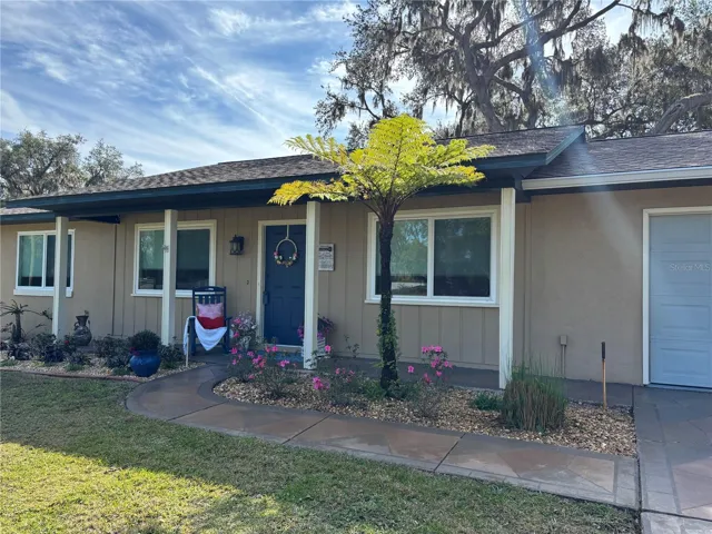 Beautiful covered front patio with one car garage, new high impact windows, and brand new garage door