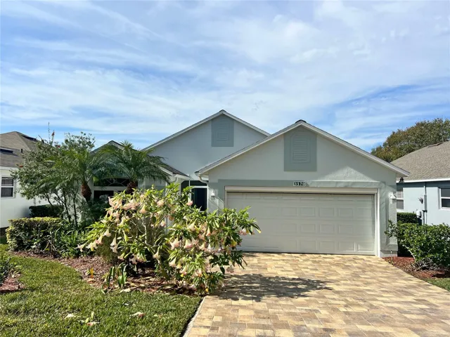 Front exterior with garage door screen, pavers on driveway, Roof only 4 years old, gutters