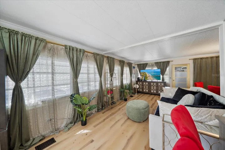 Length of living room . . .  (note quality vinyl flooring throughout)