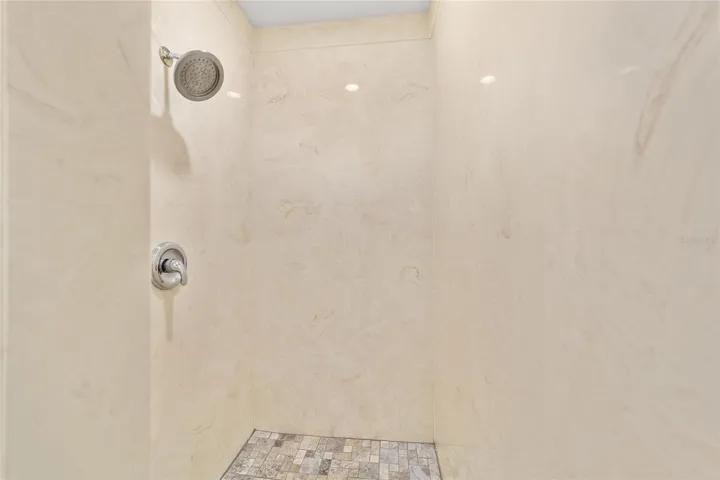 Master bathroom stall with updated flooring