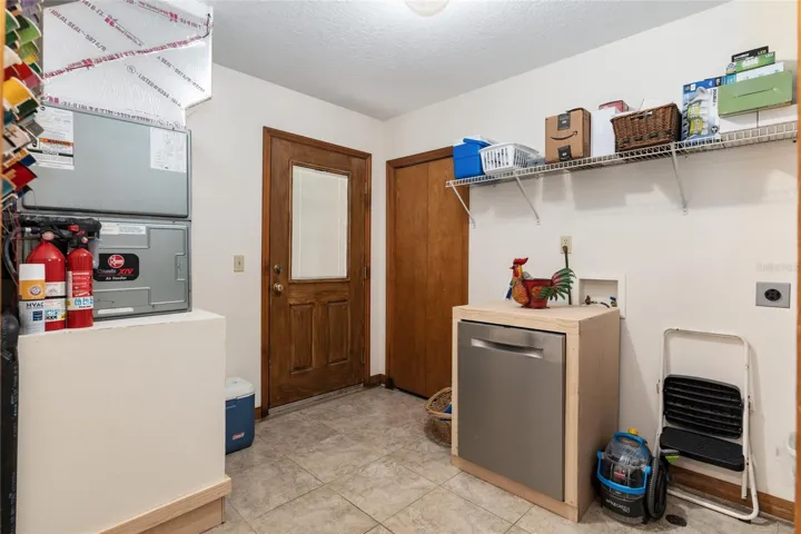 Interior laundry room with separate entry.
