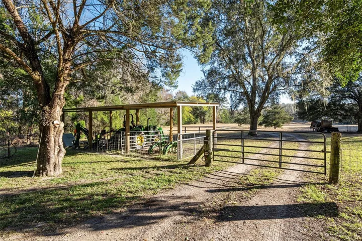 Motorized entry/exit for tractor/tools lean-to