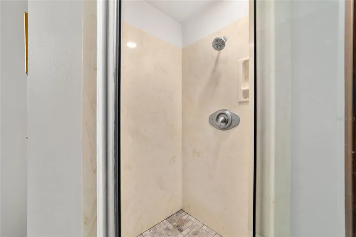 Walk-in shower stall with updated flooring