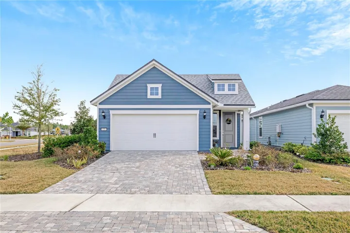 Front with paver driveway and walkway