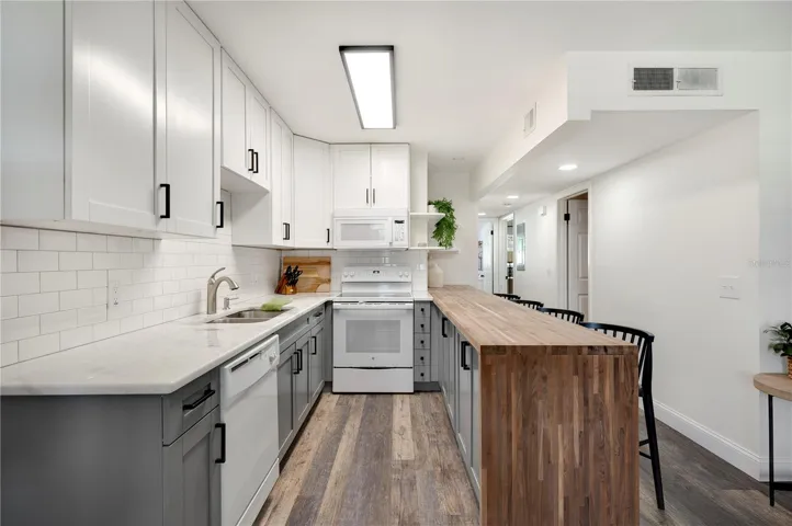 White & Grey cabinetry adorn the kitchens main prep area.