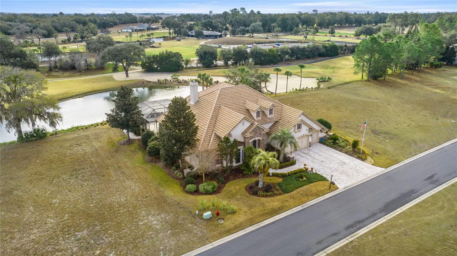 Front aerial view of home overlooking water and the golf course