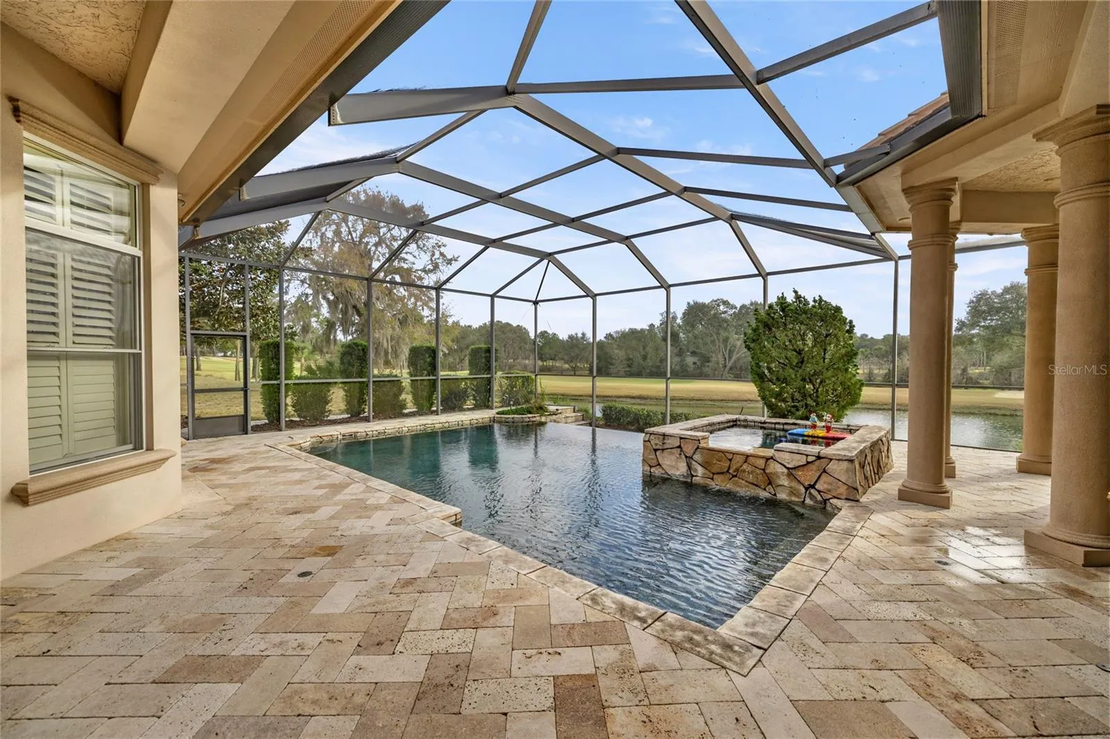 Enclosed infinity pool and outdoor kitchen