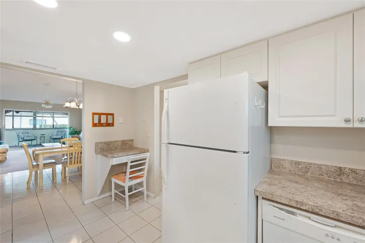 Full Size refrigerator, dishwasher and a small desk area in the kitchen