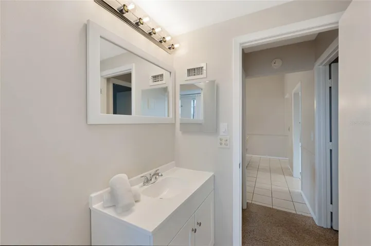 Guest bathroom with new vanity, mirror, fixtures and recessed lighting