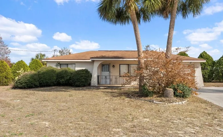 The Front of the Home includes gorgeous palm trees