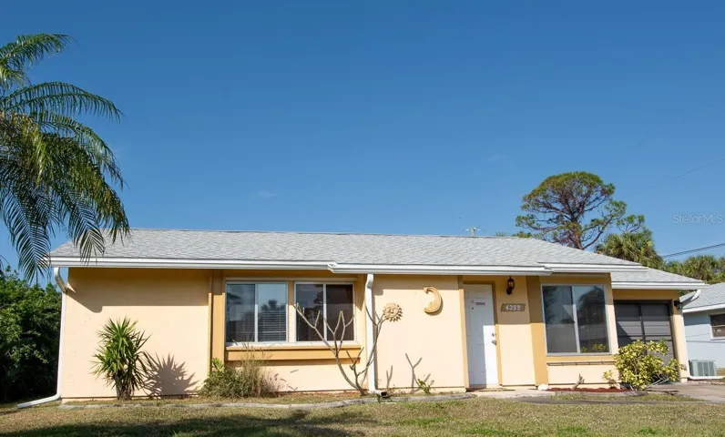 Charming 2/2/1 with enclosed back patio and two storage sheds - plus, a backyard carport.