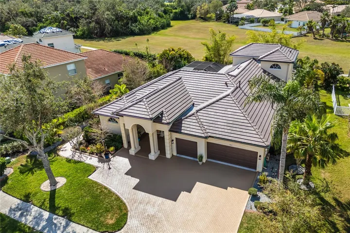 New Tile roof, Paver driveway, curbing with stone outline the lush tropical Florida Palms 12810 Daily Place, Bradenton, FL 34212 located in highly desirable Greyhawk Landing community, HOA $75 a year with resort style amenities, HOA $75 a year.
