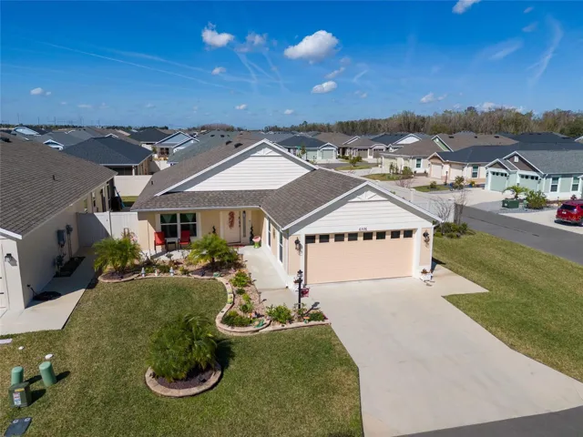 6576 Merrill Lane, The Villages - Elevated FRONT EXTERIOR view shows ENHANCED LANDSCAPING on a  CORNER LOT w/ FENCED COURTYARD