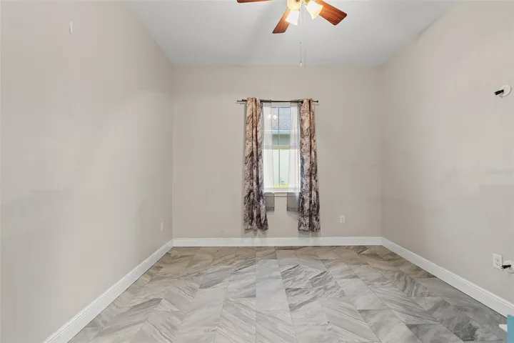 4th bedroom features tile floors and ceiling fan