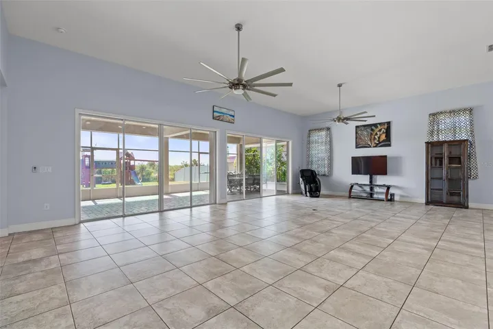 Combination dining/living areas with double sliding doors leading to screened-in covered lanai
