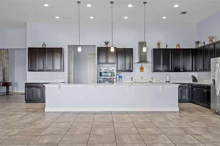Kitchen features 42" upper cabinets, stone countertop. The 17' island is focal point and seats 8-10 comfortably