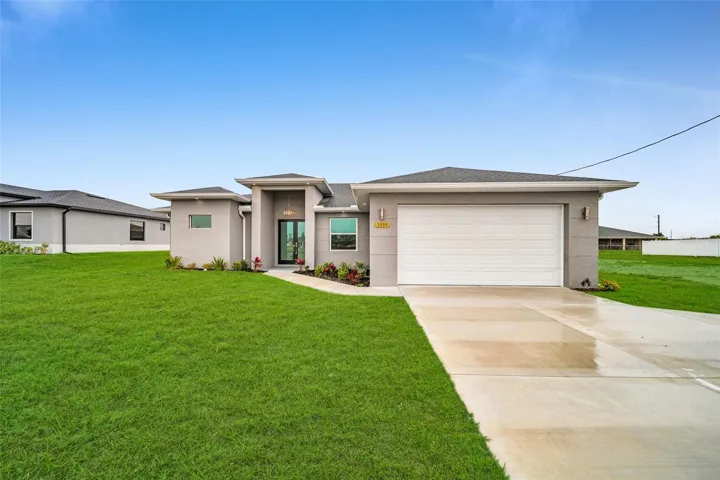 Prairie-style house with a garage and a front lawn