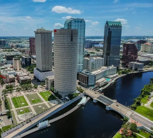 Downtown Tampa Skyline next to Hillsborough River.  Rivergate building in front next to Riverwalk.