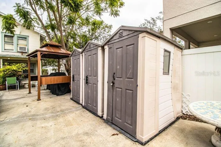 COURTYARD - THREE SOTRAGE SHEDS AND GRILL