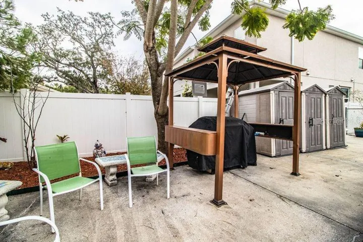 UNIT 2 AND 3 - COURTYARD SHOWING OUTSIDE GRILL, PATIO, STORAGE FOR UNITS 1-2-3
