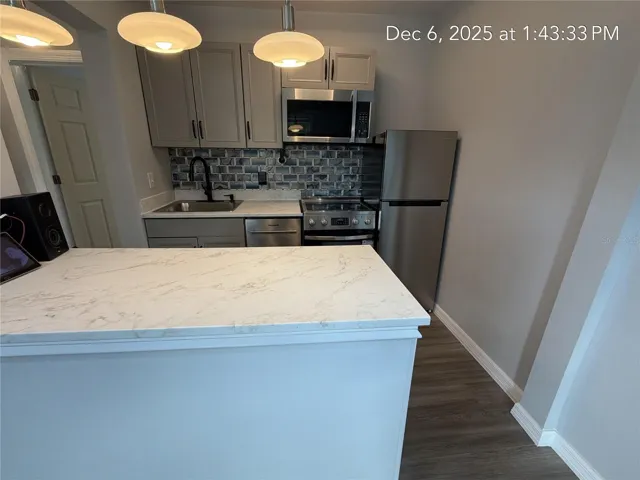UNIT 3 KITCHEN WIDE SHOWING BAR AND ALL APPLIANCES