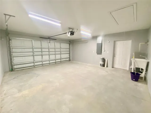 double car garage with side service door & utility sink