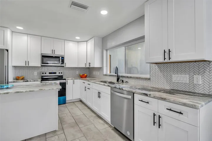 Kitchen with sliding window to Lanai