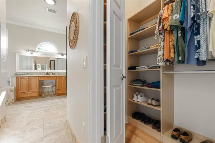 Primary bedroom closet with custom built-ins