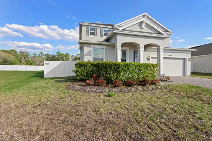 Front elevation. Paved driveway with 2 car garage and front porch. Easement on the left giving added pace and no direct side neighbor.